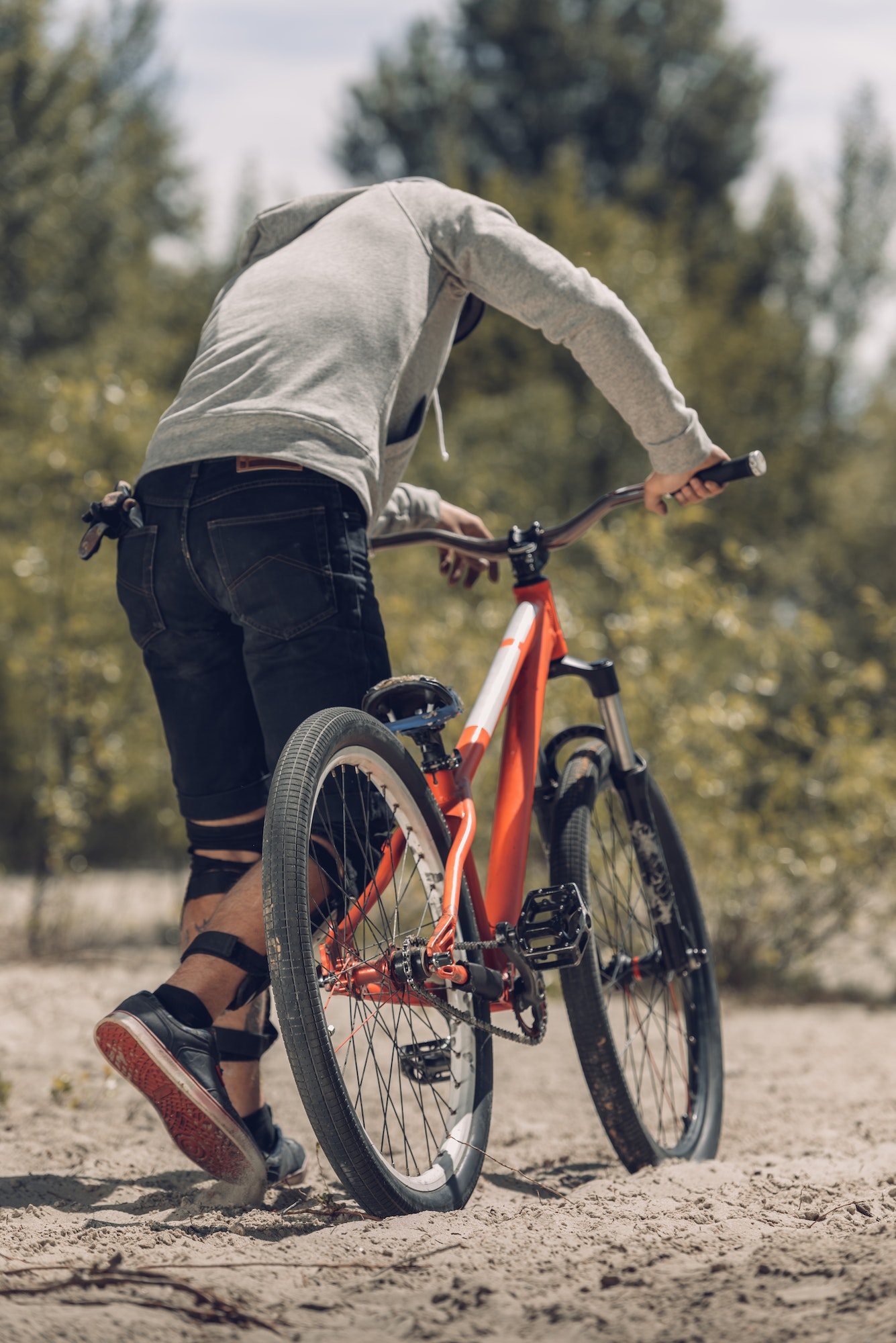 rear view of biker with mountain bike